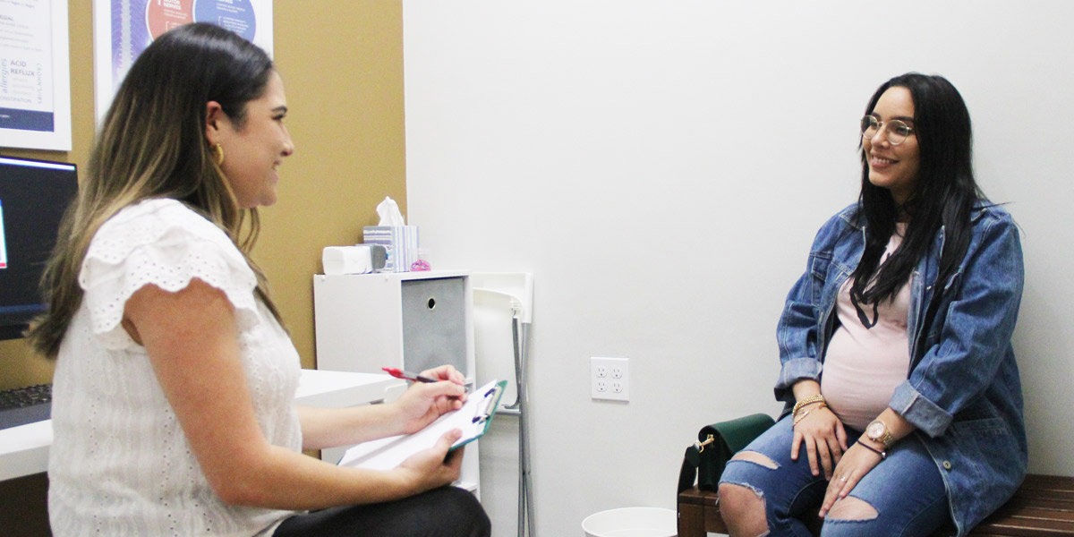 Dr. Ilean Santos having a patient consultation with a pregnant woman
