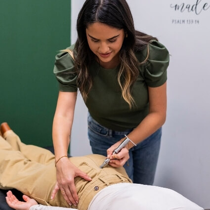 Orlando chiropractor Dr. Ilean Santos gently performing torque release method on child