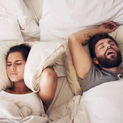 couple on bed sleep apnoea