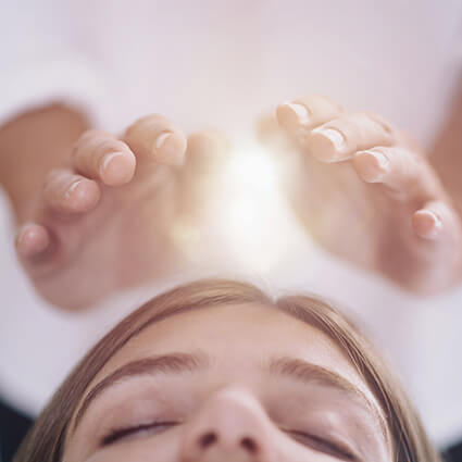 Woman getting Reiki treatment