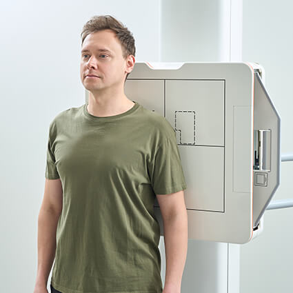 person standing in front of scanning machine