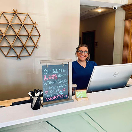 Woman standing behind desk