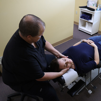 Dr. James Neil adjusting patient's neck