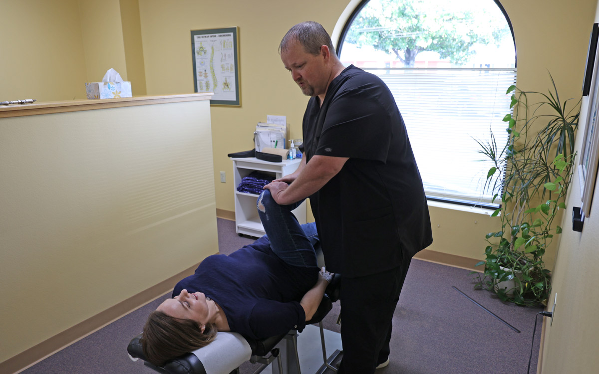 Dr. James Neil adjusting patient
