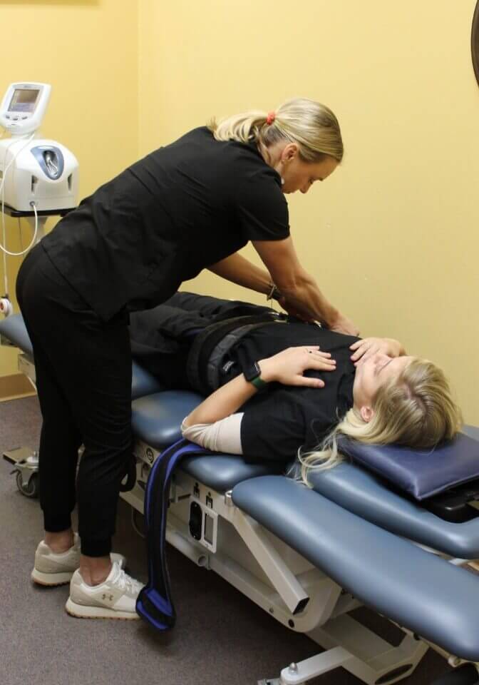 Chiropractor adjusting patient