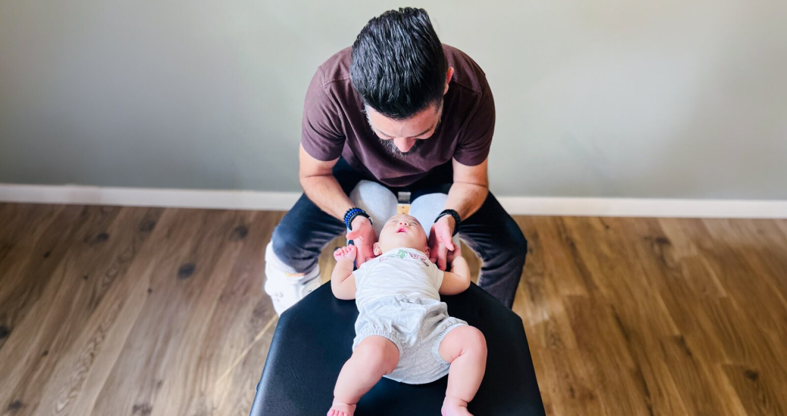 Chiropractor adjusting baby