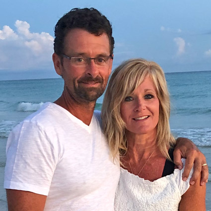 Dr. Richard Charpentier with his partner on the beach