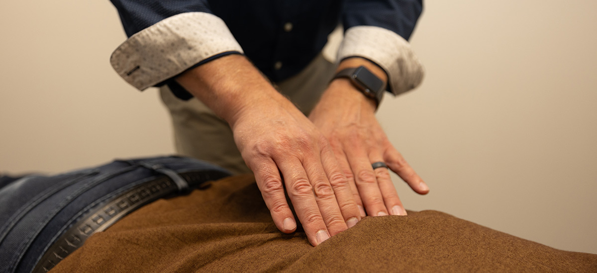 chiropractor adjusting persons back