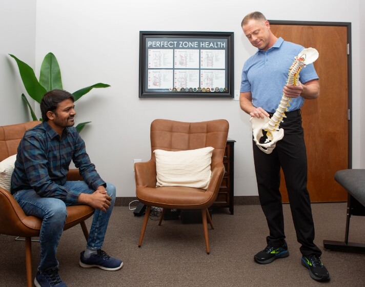 man holding spine model