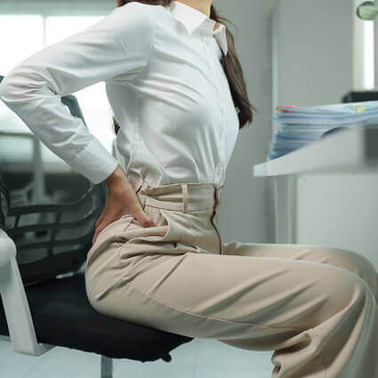 business woman at desk with lower back pain