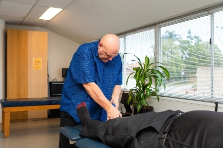 Patient getting his leg adjusted