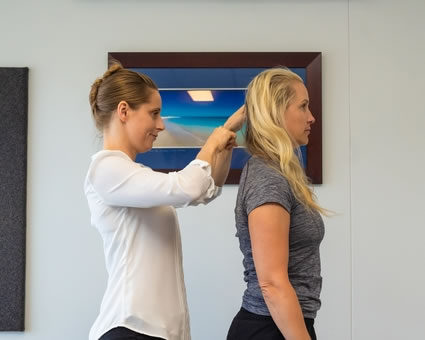 Dr Jenae checking patient's spine