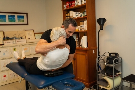 Chiropractor adjusting a female patient