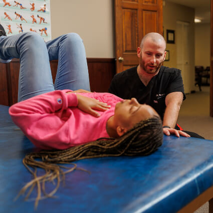 Glen Carbon Chiropractor Dr. Brad with woman receiving treatment