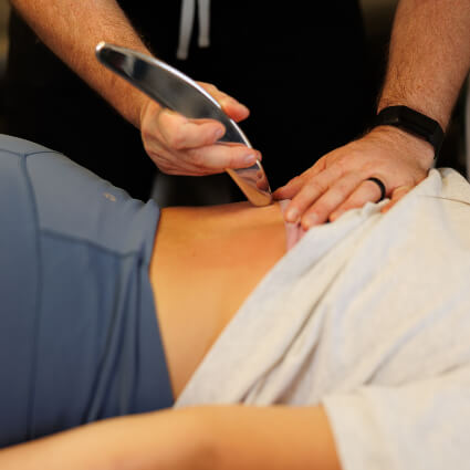 Chiropractor justing instrument to massage back