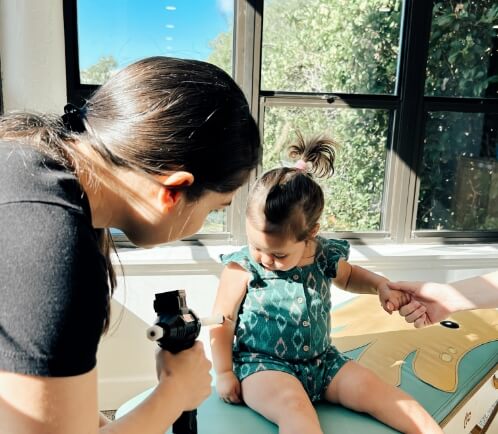 Chiropractor checking baby
