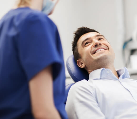 man looking up from dental chair