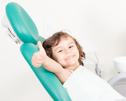 Little girl sitting on a dental chair