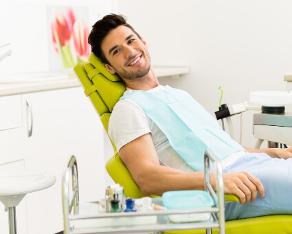 Male patient sitting on dental chair