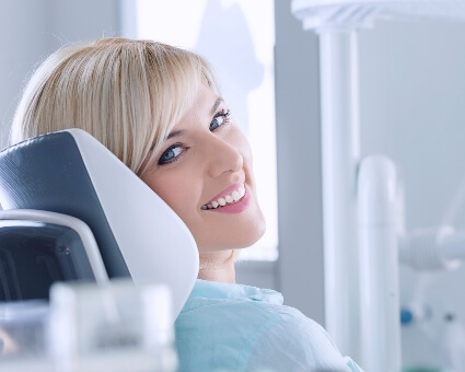 Smiling woman sitting on a dental chair