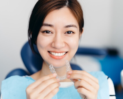 Woman holding invisalign