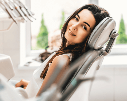 Smiling woman sitting on a dental chair