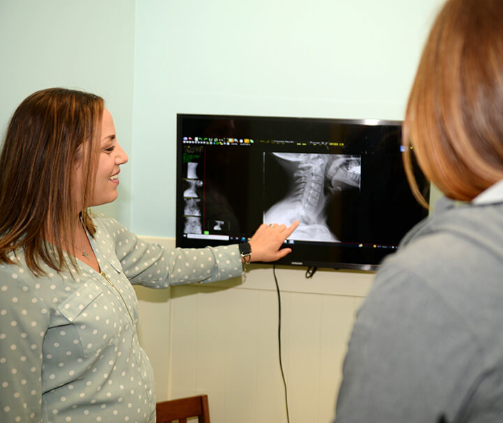 Chiropractor pointing at x-ray