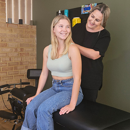 Dr Melinda adjusting persons shoulder