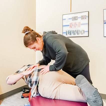 Dr Tamara adjusting persons back