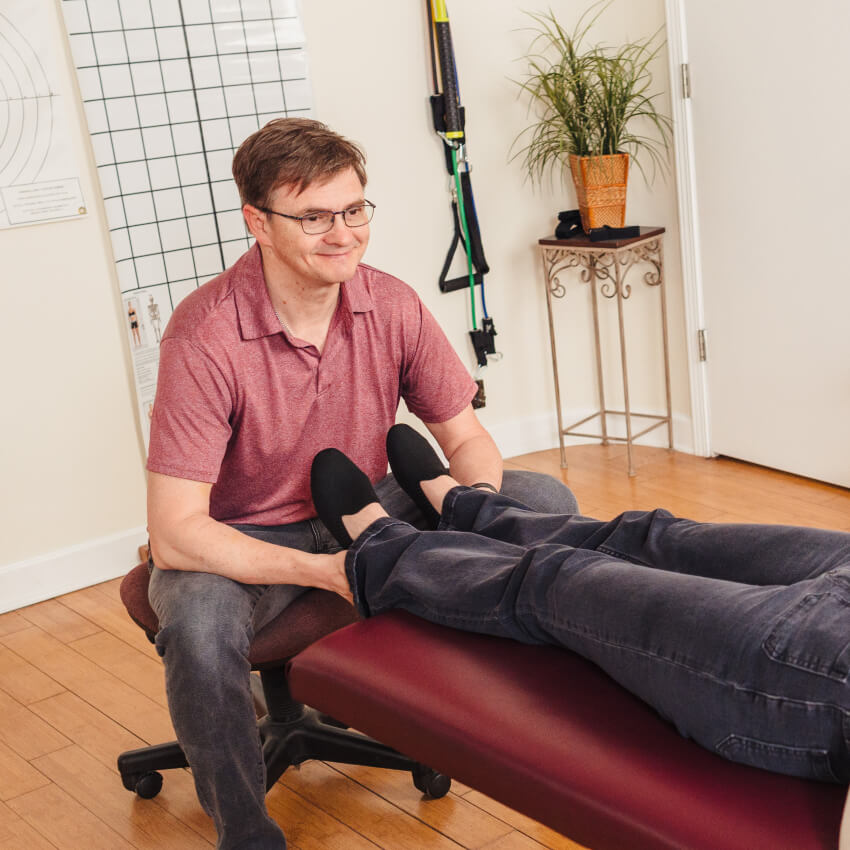 Naperville chiropractor Dr Haug examining patients feet
