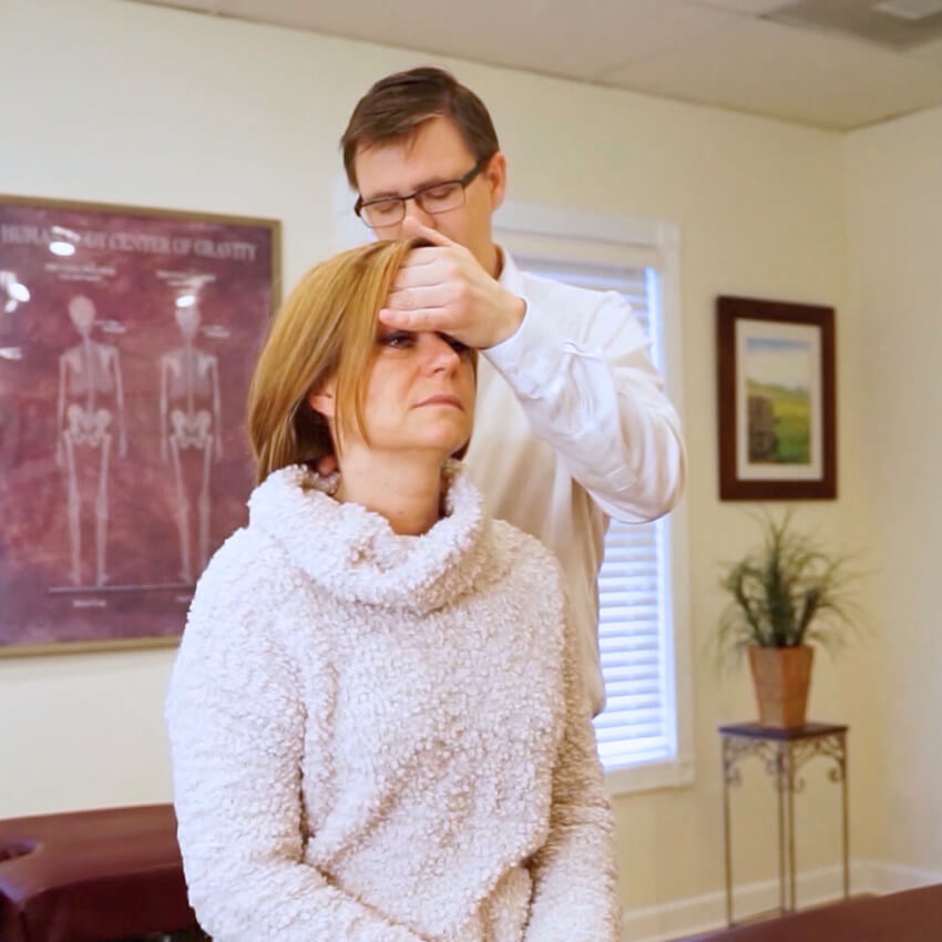 Haug Chiropractic patient having neck examined
