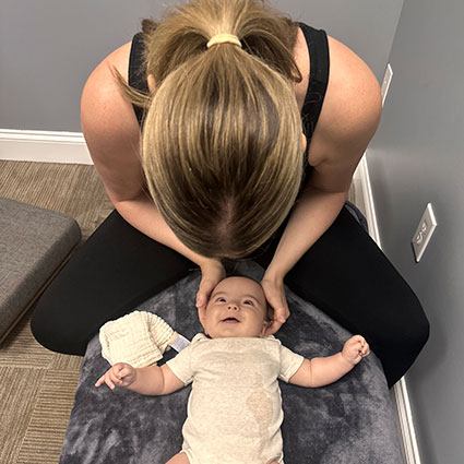 Dr. Megan adjusting baby