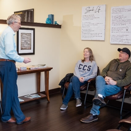 Dr Ludwig talking to patients in waiting area