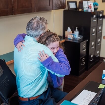 child hugging Dr Ludwig