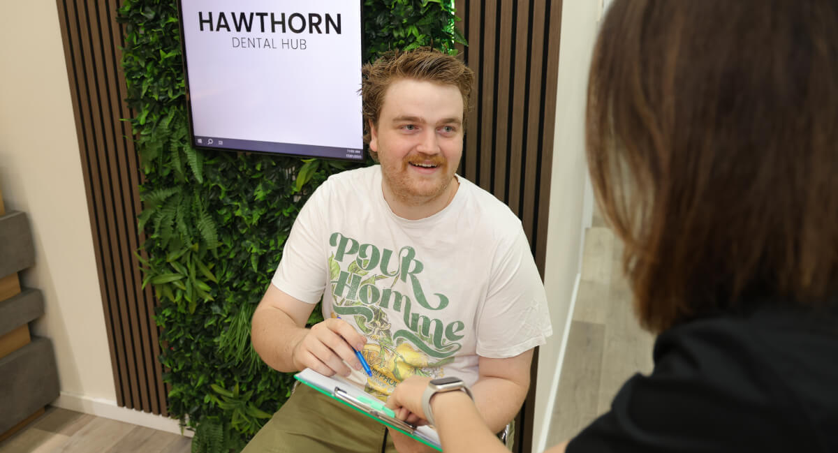 Hawthorn East dentist Dr Nina discussing paperwork with new patient