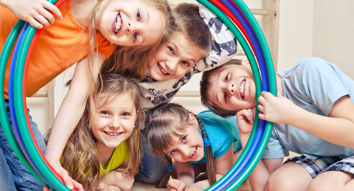 Kids posing with colored hoops