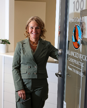 Colorado Springs Chiropractor Dr. Lynn holding open door