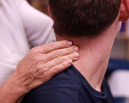 Pressing on patient's neck