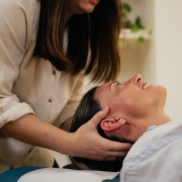 Female patient getting her neck adjusted