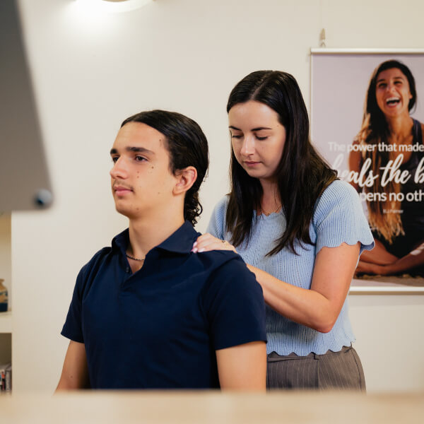 Male patient receiving a chiropractic shoulder adjustment