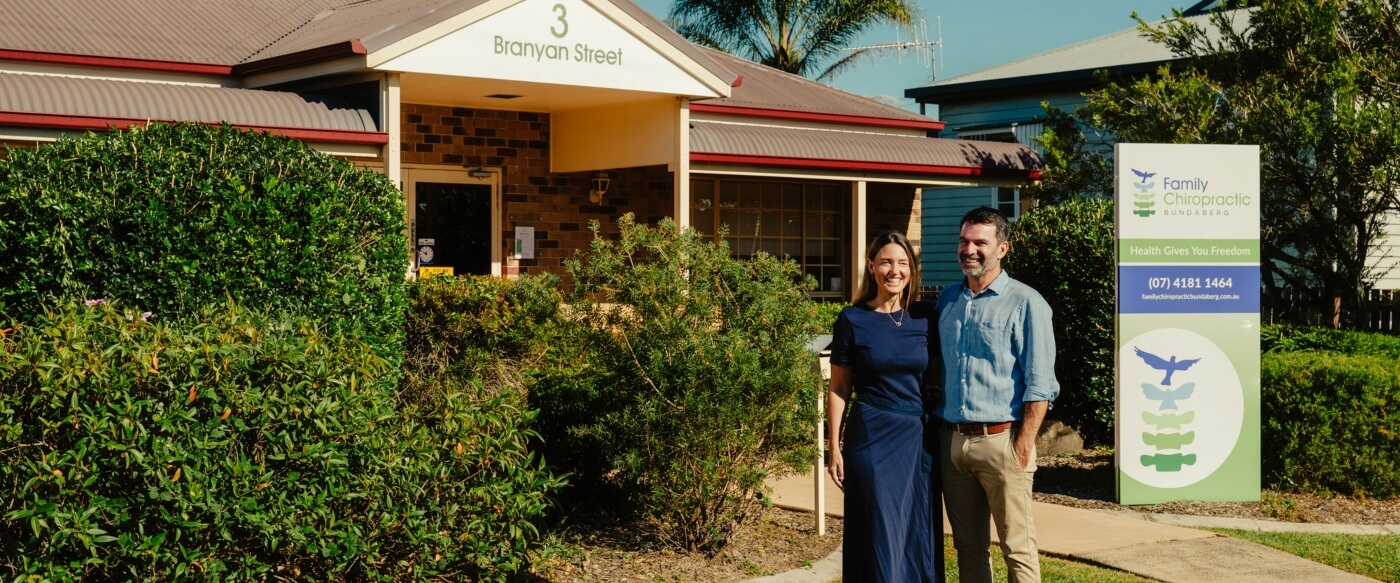 Chiropractors standing outside the office
