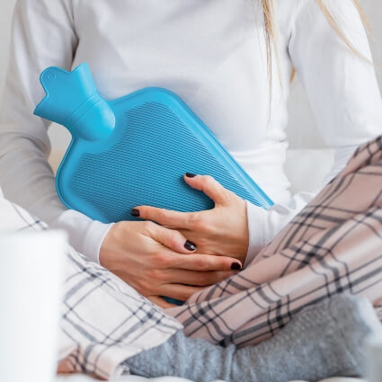 hot water bottle on womans stomach