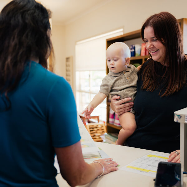 Receptionist talking to a patient