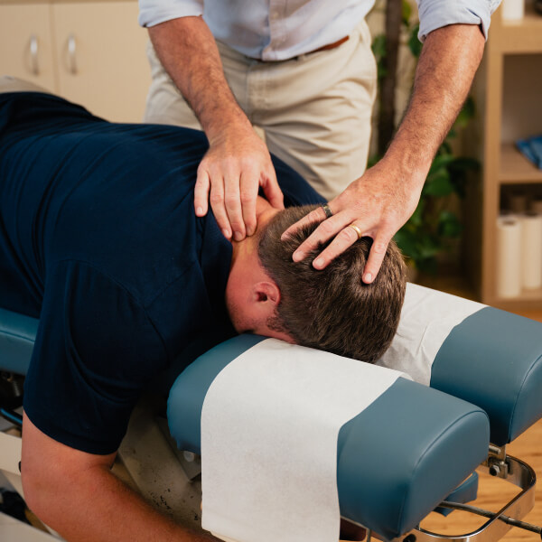 Chiropractor adjusting patient's neck