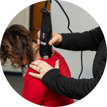 Chiropractic adjustment tool being used on a patient's neck