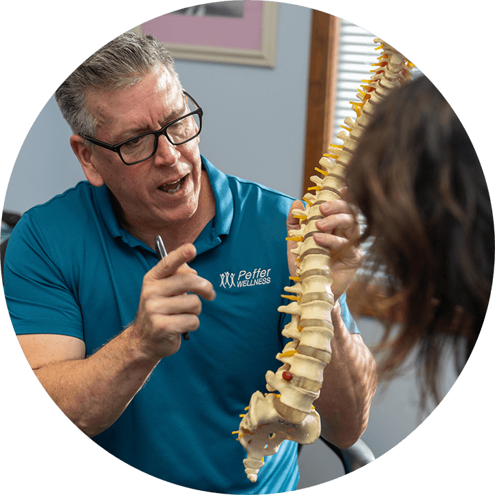 Dr. Michael showing a 3d model of a spine to a patient