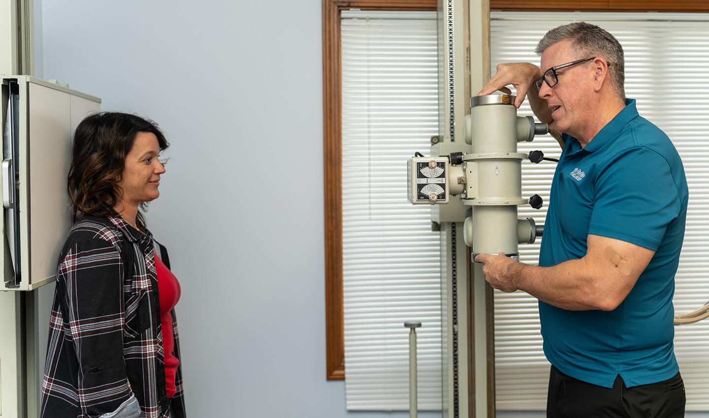 Chiropractor taking x-rays of patient