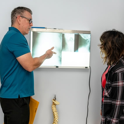 Dr. Michael Peffer showing x-rays to patient