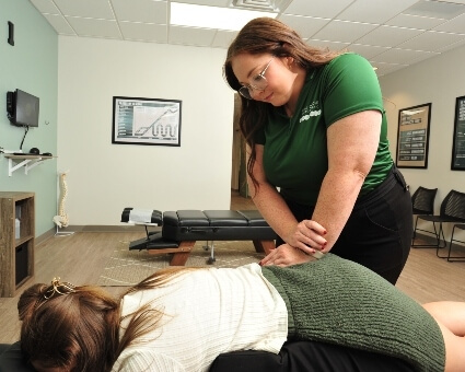 Lower-back adjustment used on female patient