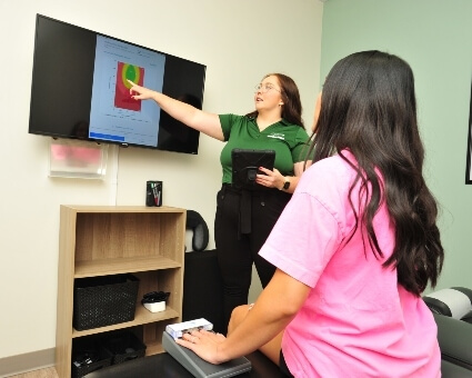 New Practice Members Chiropractor in consultation with patient